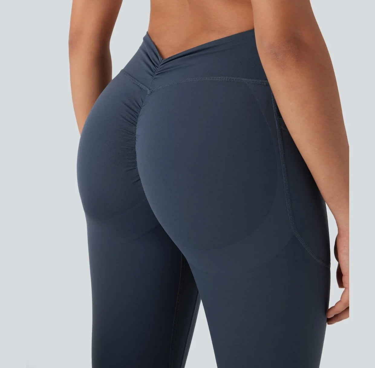 High-waisted yoga pants with a V-shaped waistline design that cinches the waist.