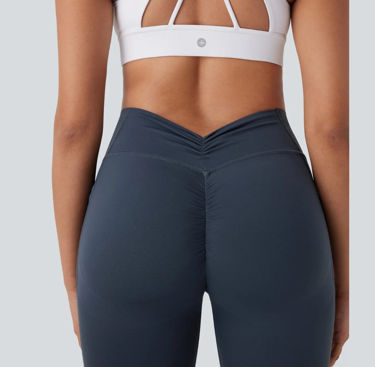 High-waisted yoga pants with a V-shaped waistline design that cinches the waist.